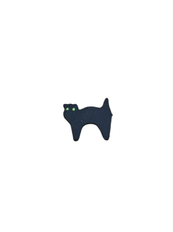 A flat, black icing decoration in the shape of a cat with green eyes, designed for cake decorating.