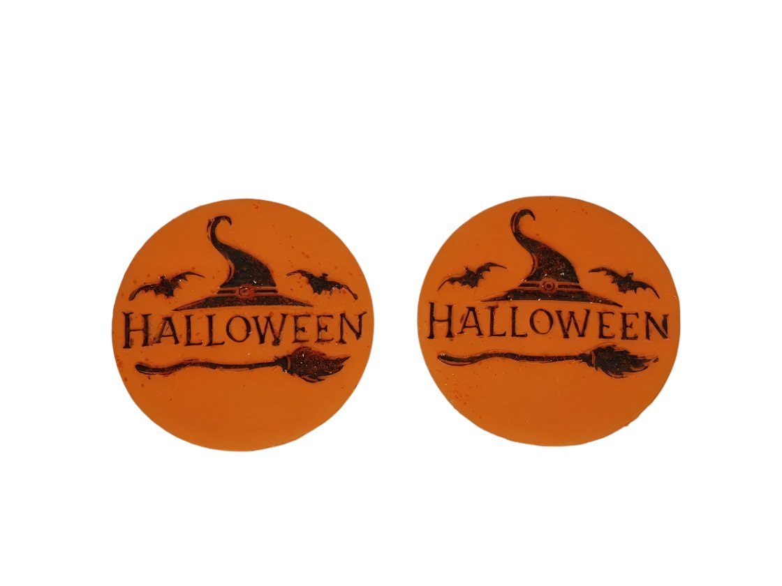 Two round orange icing discs with Halloween-themed decorations including the word 'Halloween' and a witch's hat.