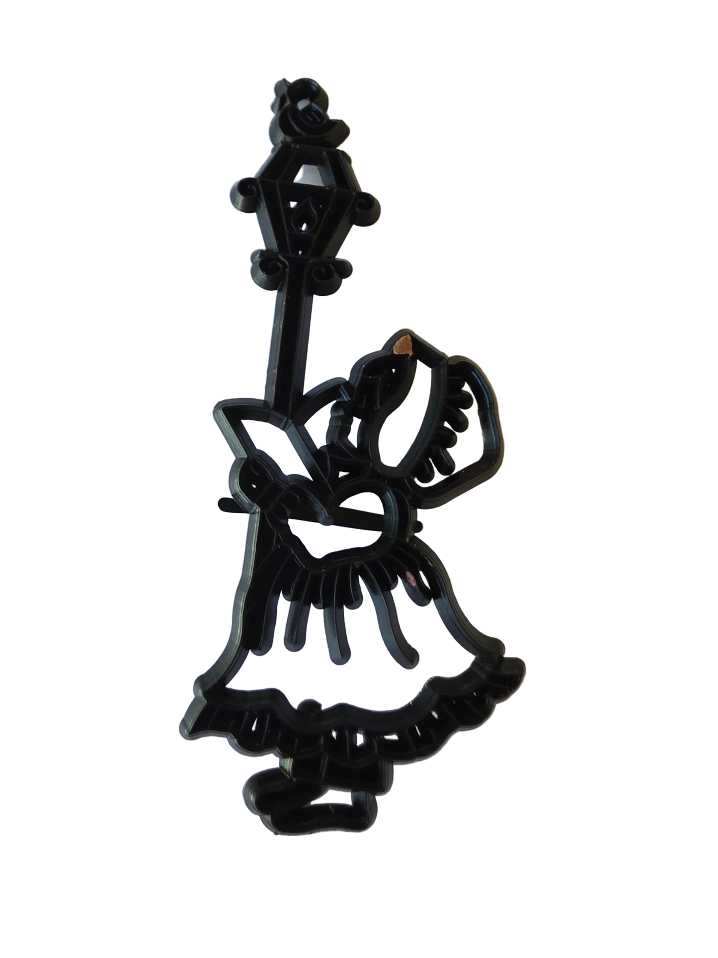 Patchwork Cutters Carol Singer silhouette by Marion Frost, standing beside an old‑fashioned lantern on a pole.
