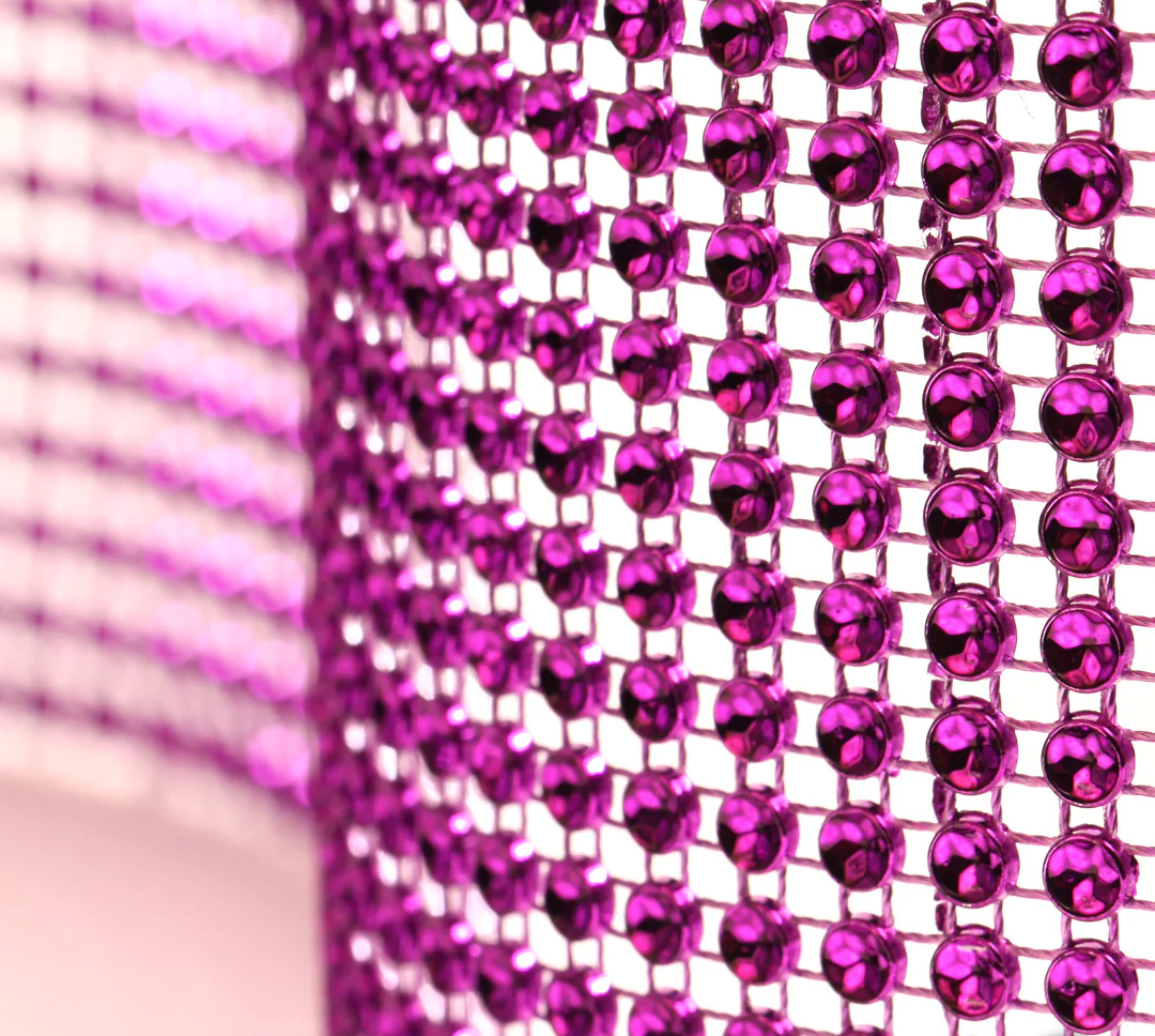 Purple glam ribbon with sparkling concaved stone shapes that create a diamond‑illusion shine. Non‑edible decorative ribbon for cakes and event décor.