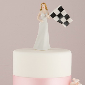 Hand‑painted porcelain bride holding a checkered flag cake topper, 13cm tall.