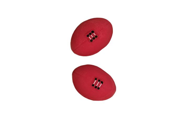 Two medium-sized, red 2D half football icing decorations for cakes.