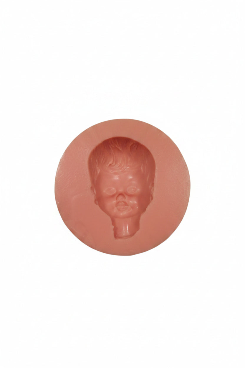Silicone mold with a head-shaped cavity on a white background