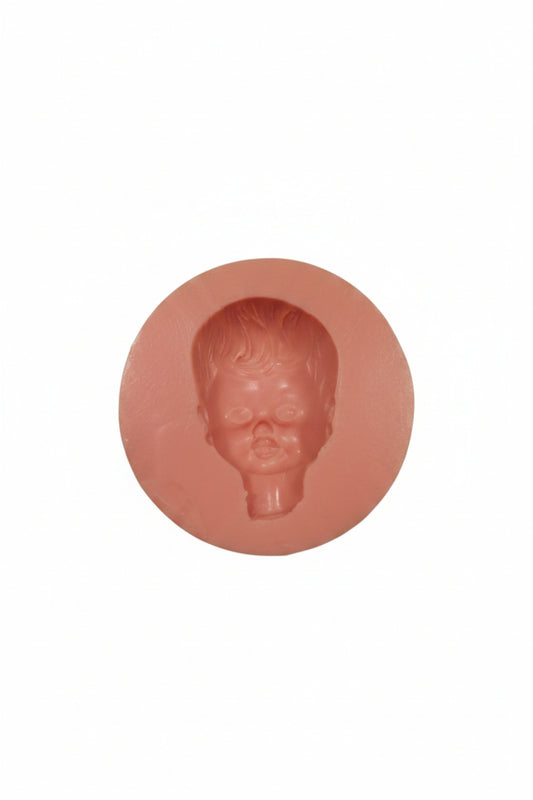 Silicone mold with a head-shaped cavity on a white background