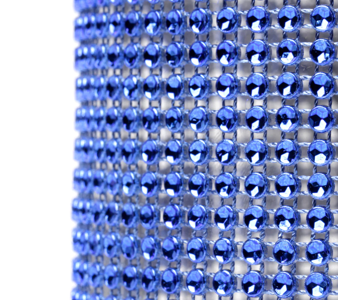 Close‑up of a blue glam ribbon showing faceted stone shapes that reflect light and give a diamond‑like shine.