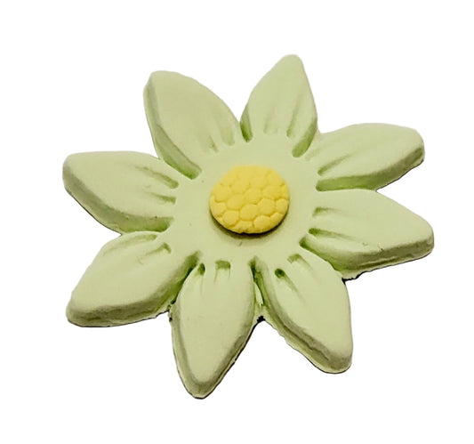 A small, pale green gum paste daisy with a yellow centre, designed for use as a cupcake or cake decoration.