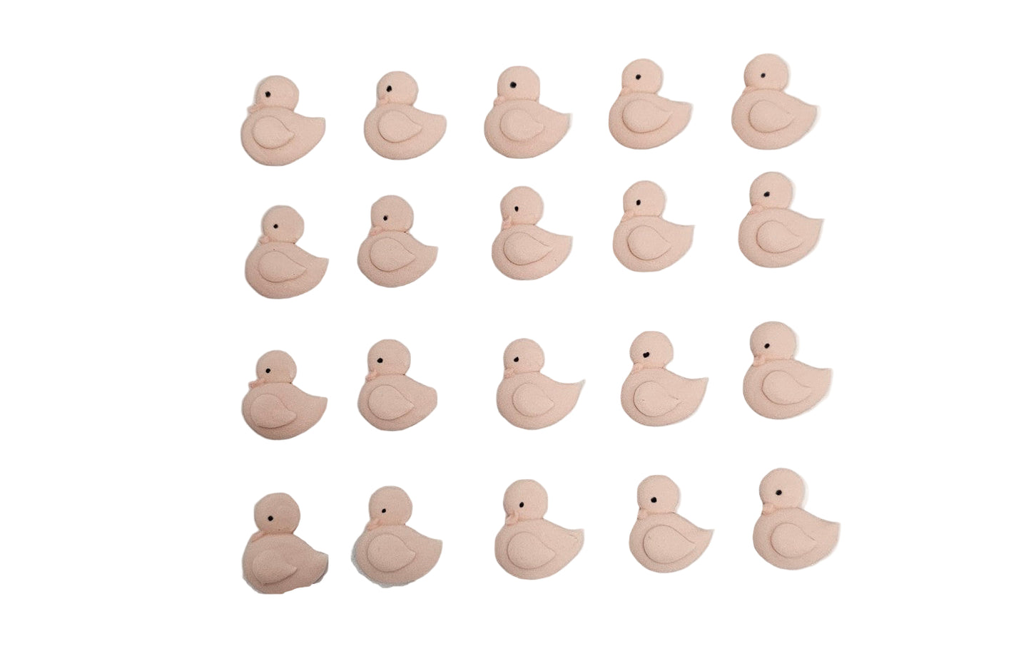 Pink duck-shaped royal icing on a white paper