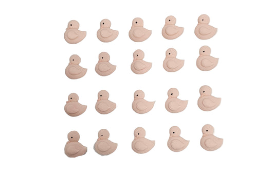 Pink duck-shaped royal icing on a white paper