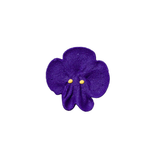A small, purple-colored edible baking decoration shaped like a violet flower with a yellow center, made of royal icing.