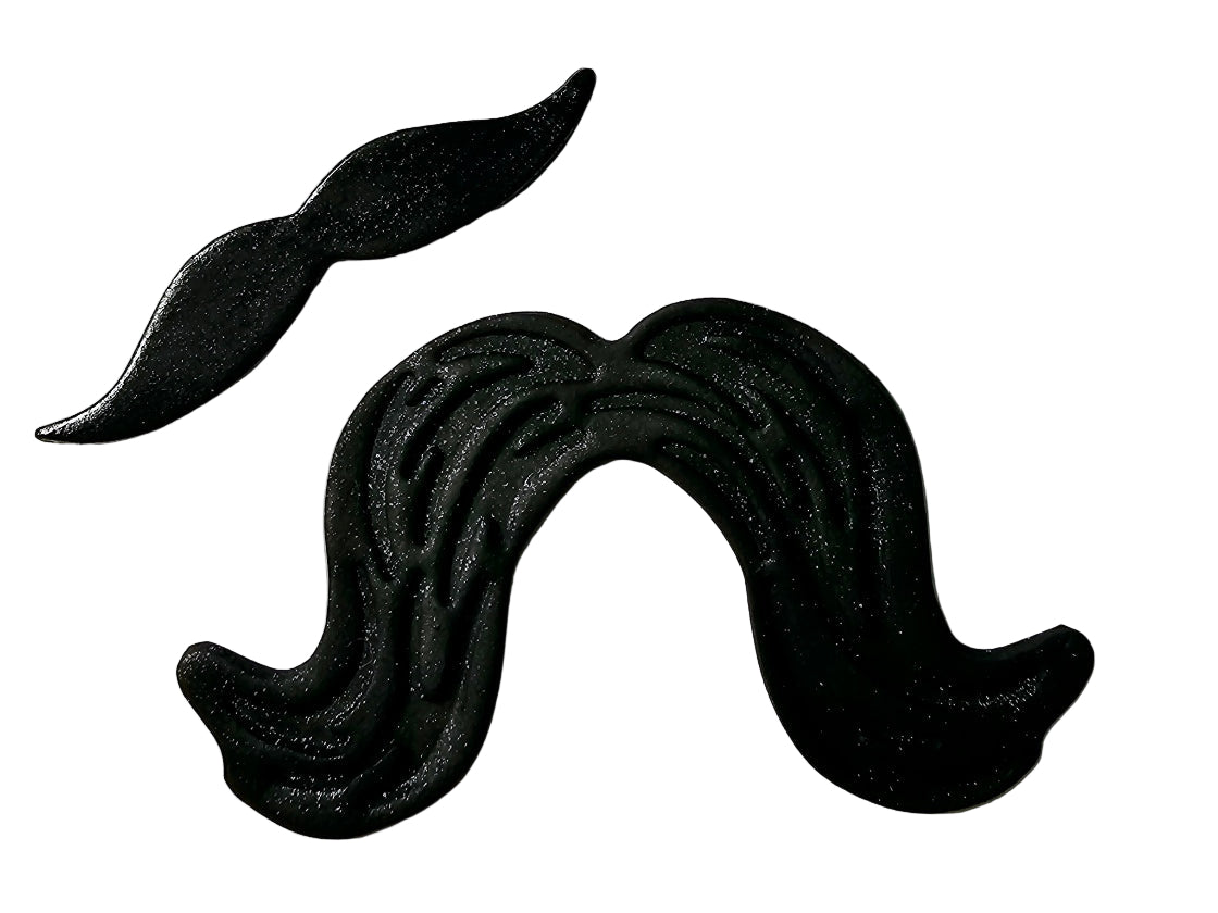 Two black icing decorations shaped like moustaches, one large and one small, on a white background.