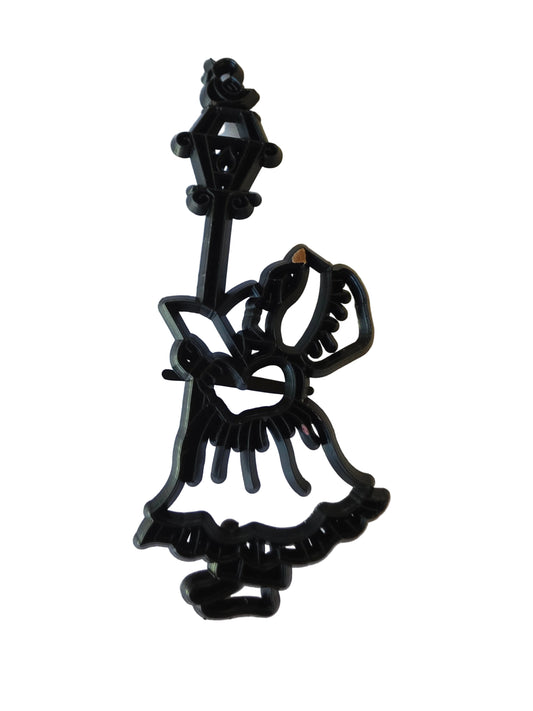 Patchwork Cutters Carol Singer silhouette by Marion Frost, standing beside an old‑fashioned lantern on a pole.