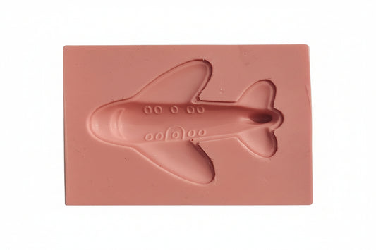 Small plane-shaped silicone mould in food-safe flexible silicone, showing detailed cavities for fondant and chocolate toppers