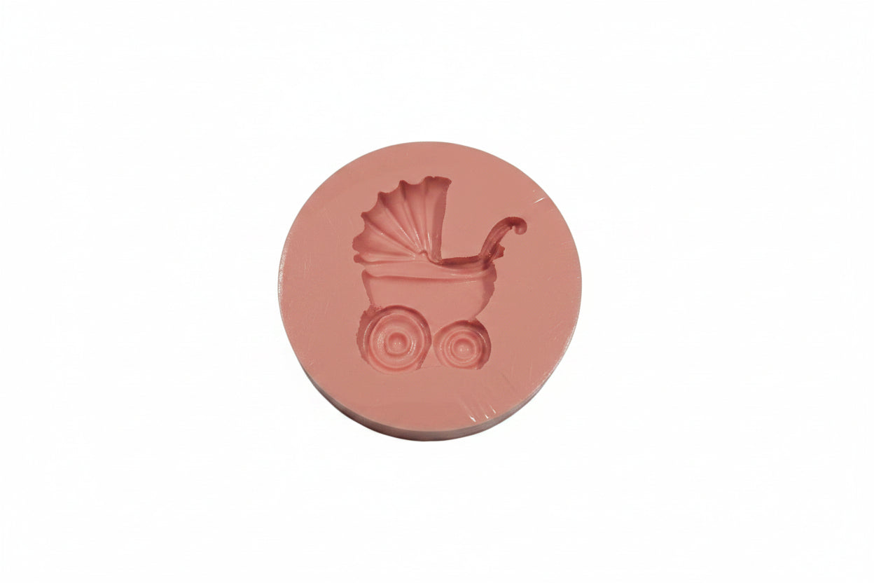 Small pram-shaped silicone mould with detailed cavities for fondant, chocolate and baby‑themed cake toppers.