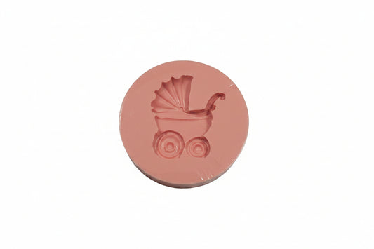 Small pram-shaped silicone mould with detailed cavities for fondant, chocolate and baby‑themed cake toppers.