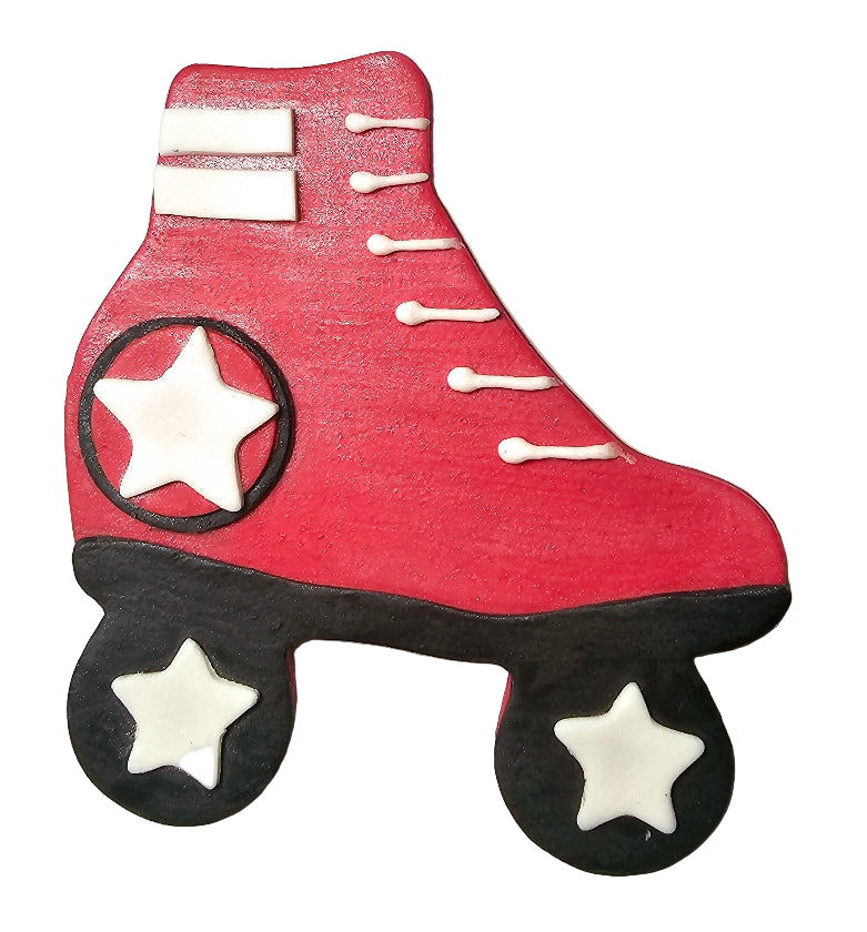 A decorative cake ornament in the shape of a red roller skate with black wheels and white accents.