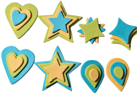 A set of edible baking decorations in assorted shapes including hearts, stars, and pillow shapes in blue, yellow, and lime green colors.
