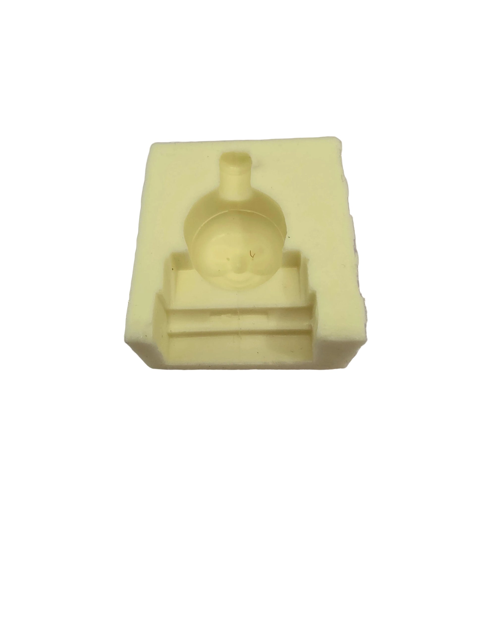 Small yellow silicone mould featuring the face of Thomas the Tank Engine, sized approximately 4cm by 3.2cm, used for fondant, chocolate or clay crafting.