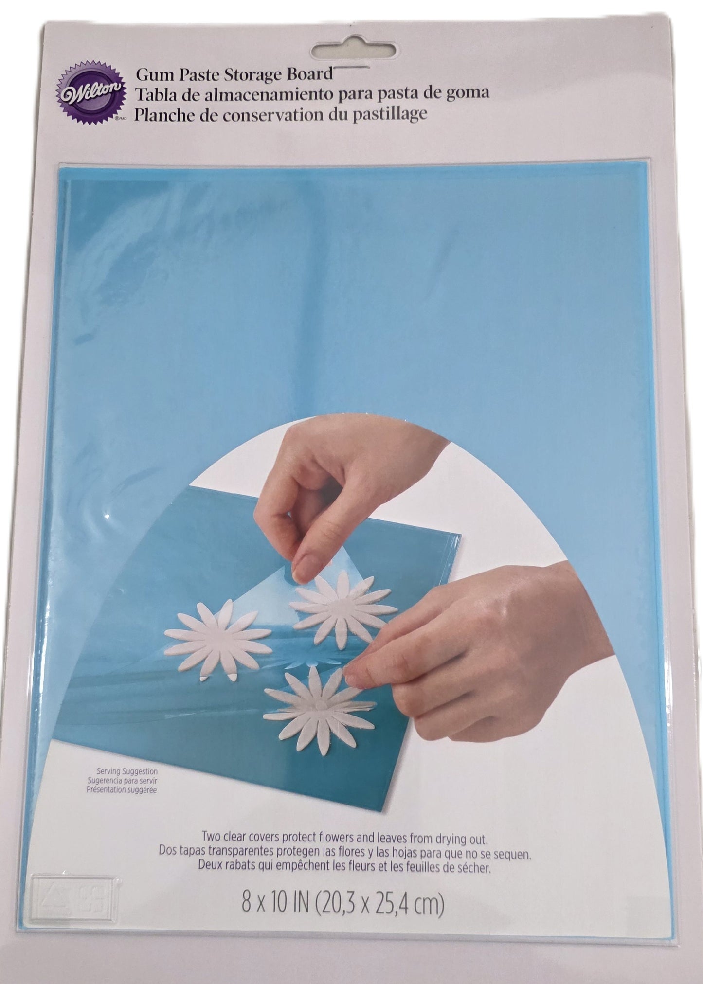 White gum paste storage board with two hinged flaps used for storing fondant and gum paste pieces.