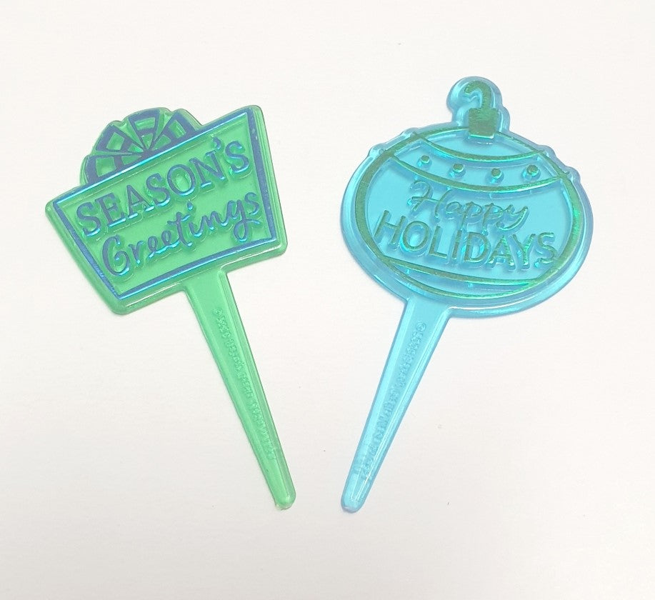 Pack of three Christmas cake picks featuring a present, Season's Greetings and Happy Holidays designs for decorating cakes and cupcakes.