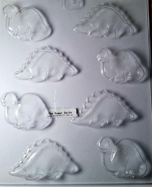 A set of clear plastic molds in the shape of dinosaurs, designed with making chocolates or fondant.