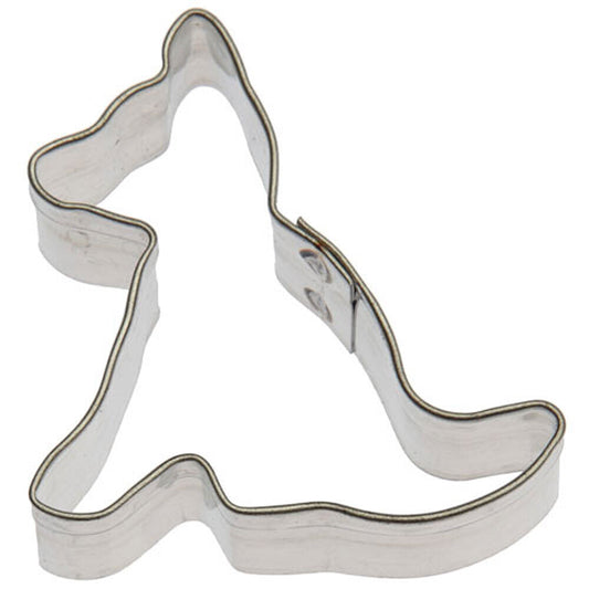 A small, silver-colored metal cookie cutter in the shape of a dog.