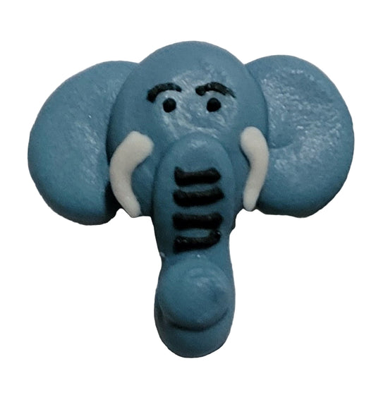 A blue grey royal icing elephant cupcake topper with a cartoonish face painted on it.