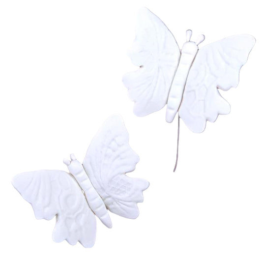 Two white embossed wired butterflies designed for cake or cupcake decoration.