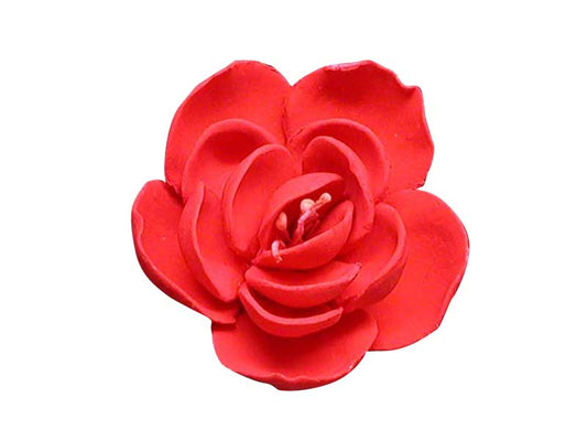 A small red, jasmine-shaped cake decoration made of gum paste with no wire and stamens in the center.