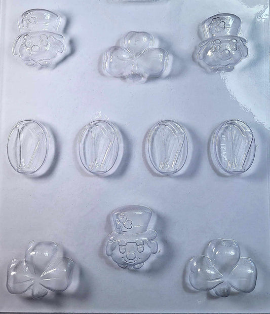 A clear plastic chocolate mold featuring shapes of Irish symbols such as a harp, a leprechaun, and three leaf clovers.