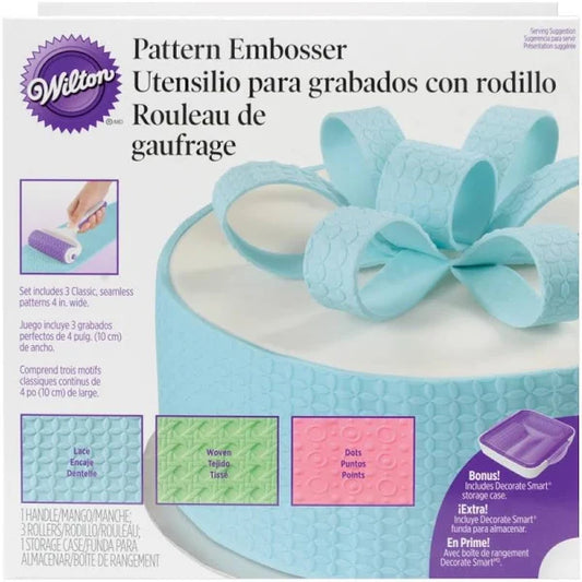 Wilton Pattern Embosser shown with its ergonomic handle, three silicone rollers in lace, woven and dot designs, and a hard plastic storage case.