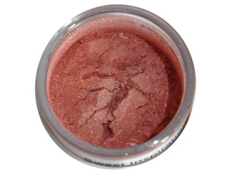A small container of pink lustre dust with a sparkled finish, used for adding color to edible decorations.