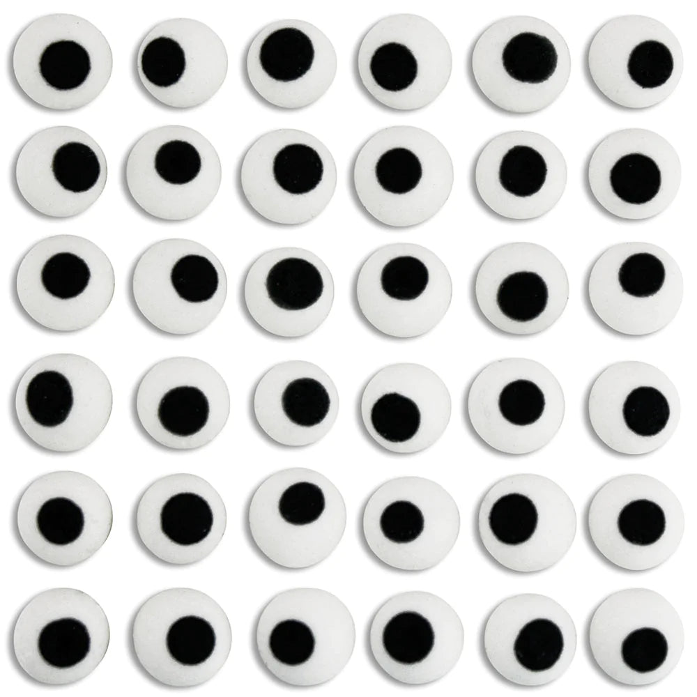 A collection of royal icing eyes used for cake decorating, displayed in rows on a white background.