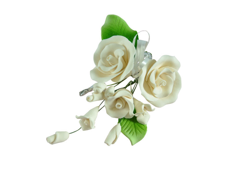 White tea rose spray with filler flowers and leaves resembling a rose made out of sugar paste.