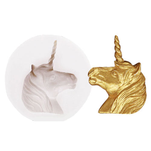 A silicone mould in the shape of a unicorn head, presented in two colors: white colour of mould and gold, intending to show the finished product.