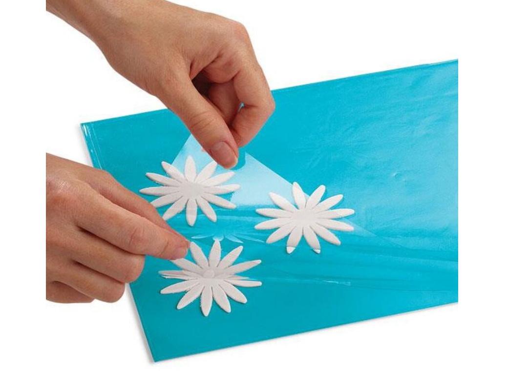 White gum paste storage board with two hinged flaps used for storing fondant and gum paste pieces.